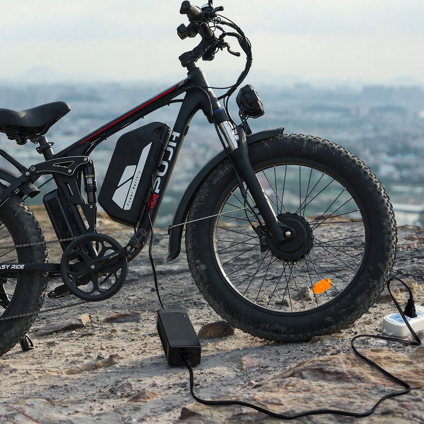 An electric bicycle being charged on the edge of a cliff.