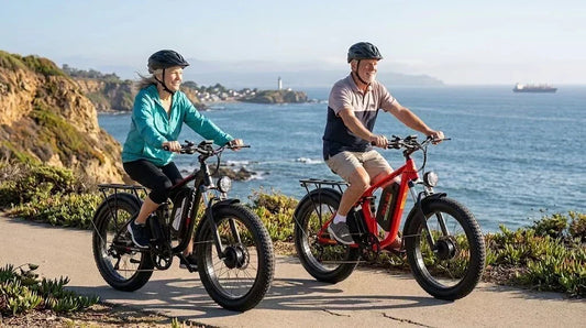 A elderly couple rides the PUJH PU366 pedal-assist electric bike for outdoor exercise on a coastal trail.