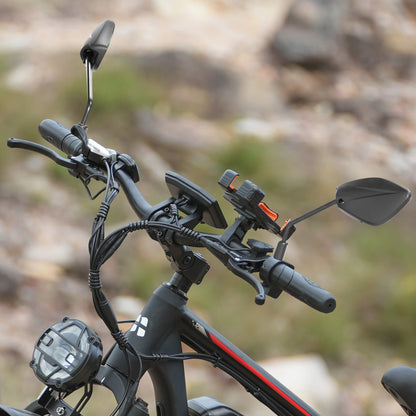 Close-up of a e-bike handlebar with controls and mirrors against a blurred natural background