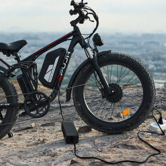 An electric bicycle being charged on the edge of a cliff.