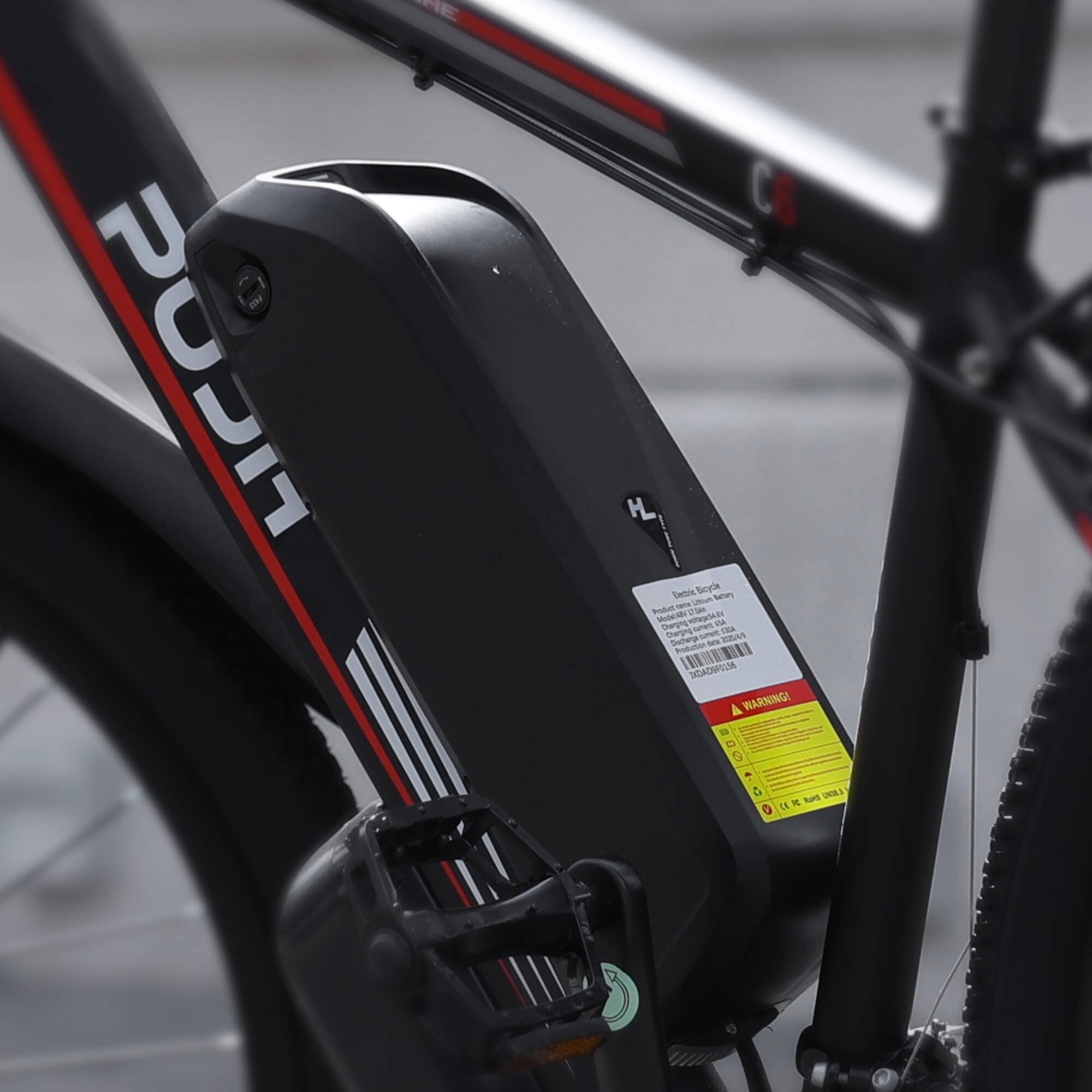 A close-up shot of an electric bicycle battery with parameters PU1-BB_Battery_48V_17.5Ah, bearing the "PUJH" brand logo.