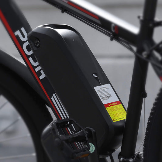 A close-up shot of an electric bicycle battery with parameters PU1-BB_Battery_48V_17.5Ah, bearing the "PUJH" brand logo.