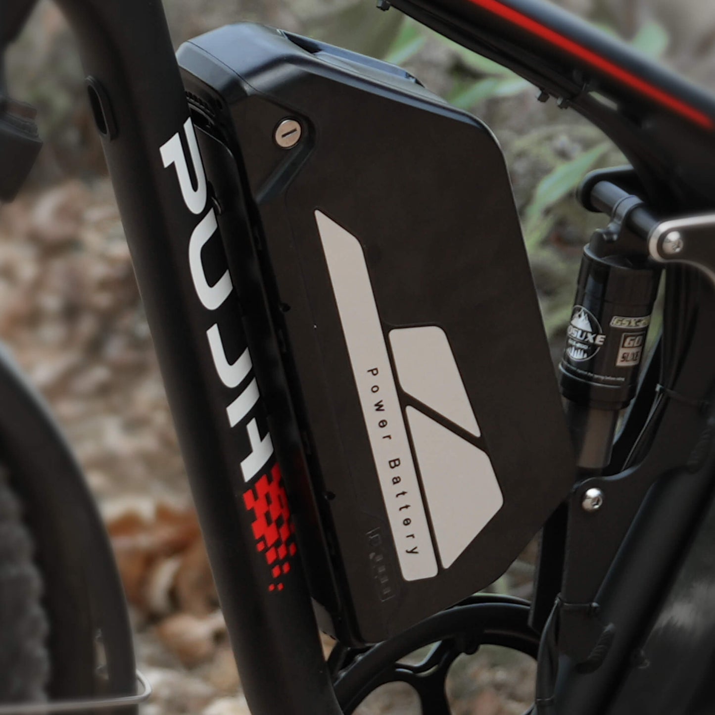 Close-up of a black electric bike battery with 'PUJH' branding.