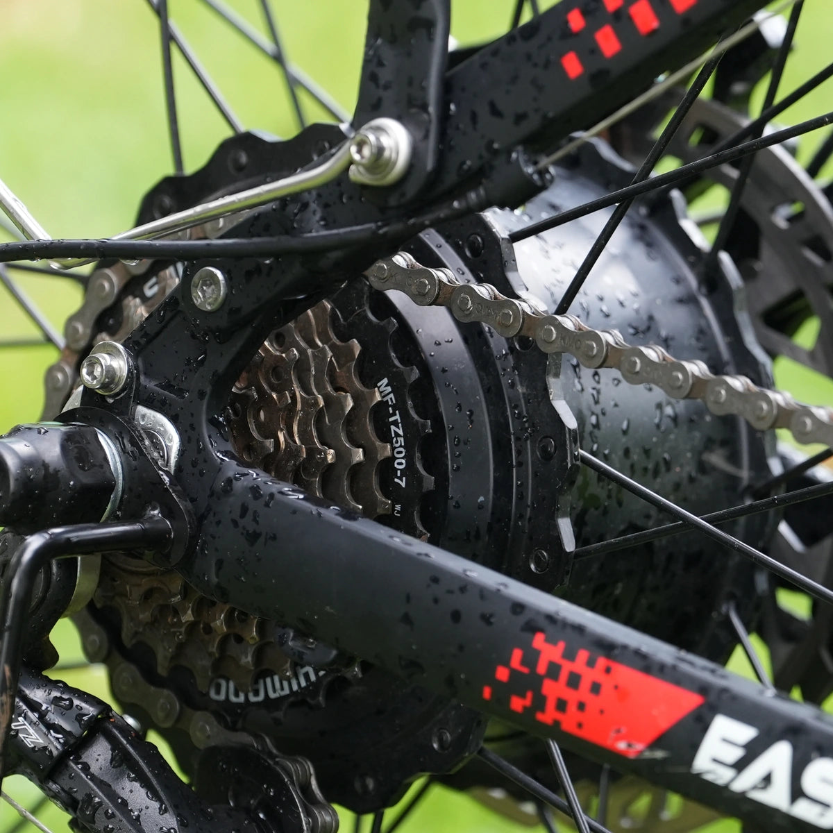 Close-up of the PUJH PU366 rear hub motor with Shimano 7-speed drivetrain on a dual motor fat tire electric bike