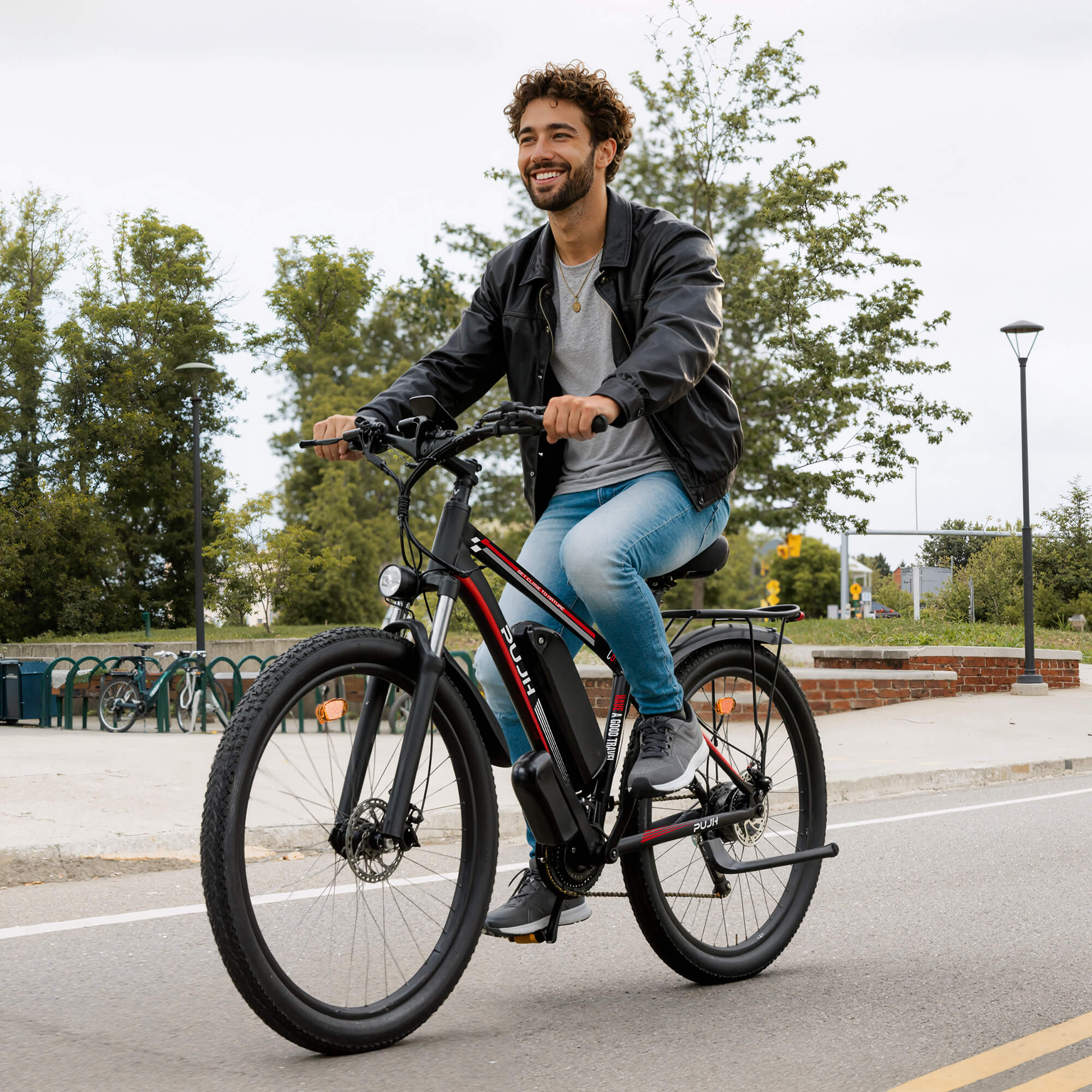 Man riding an electric bike on a street with trees and buildings in the background