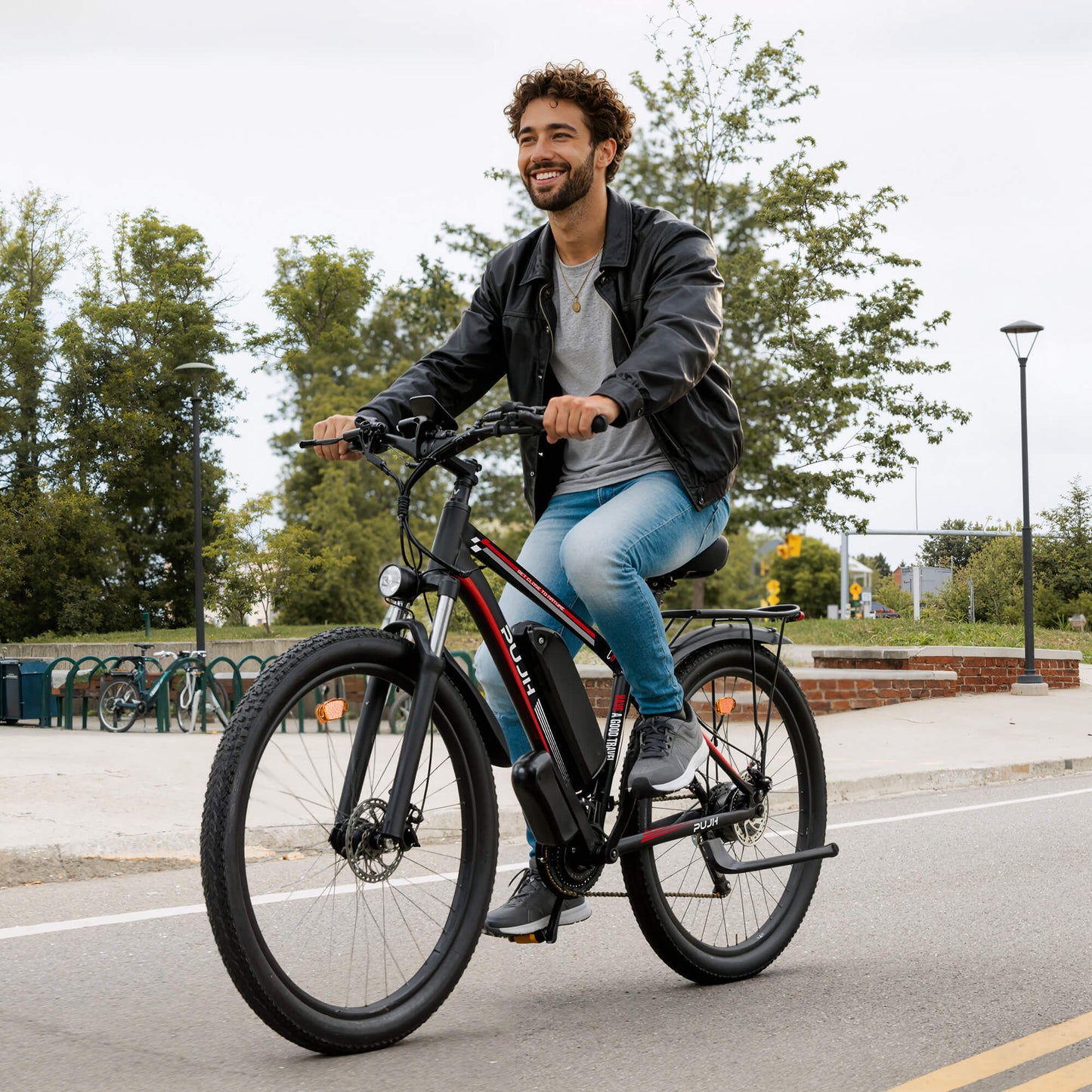 Man riding an electric bike on a street with trees and buildings in the background