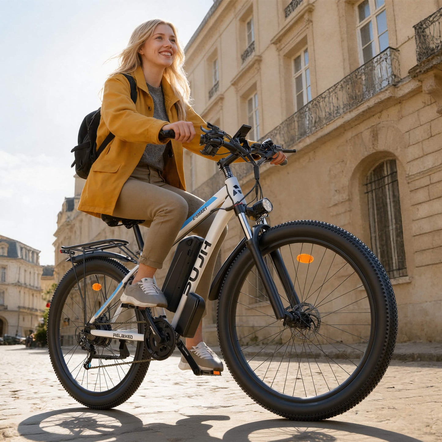 Woman riding an electric bike in an urban setting with classical architecture.
