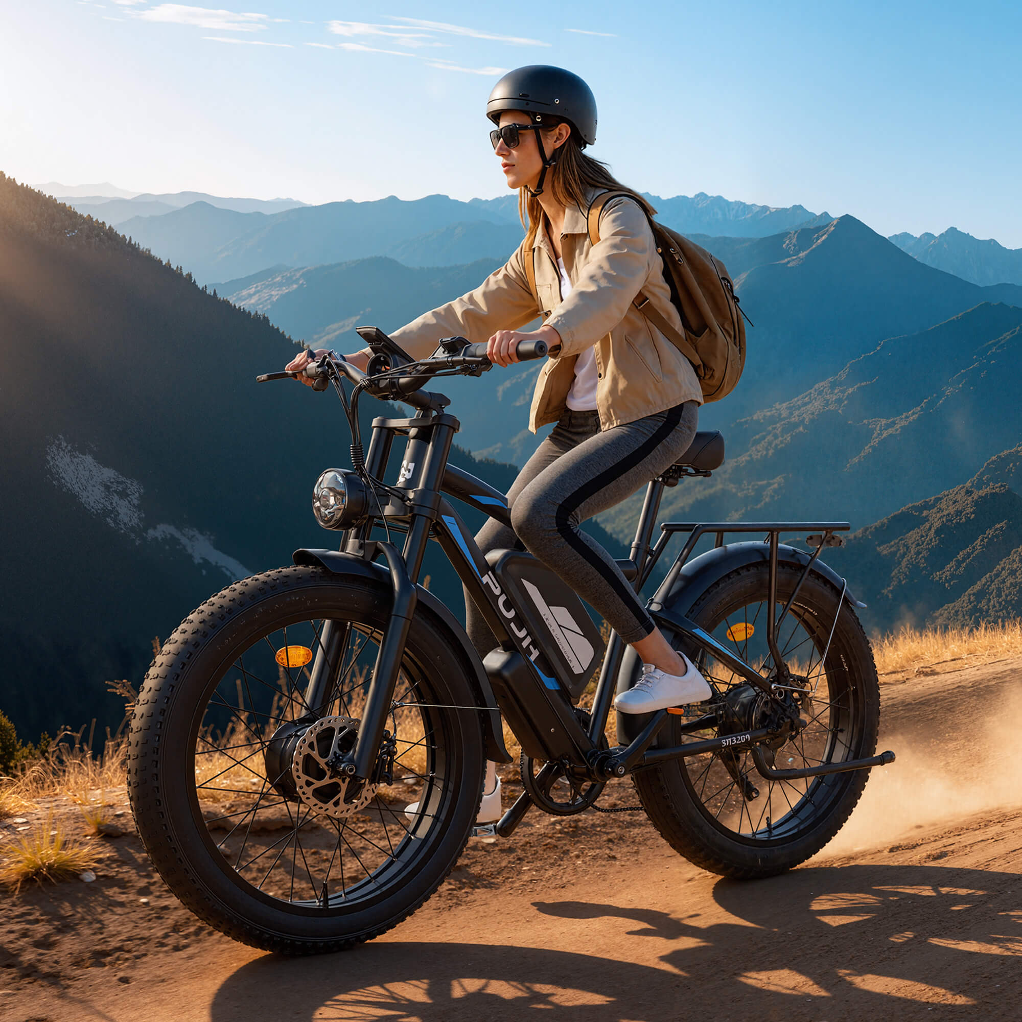 A girl riding an electric bike on a mountain trail with scenic mountains in the background